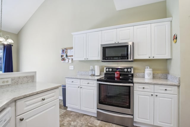 kitchen featuring lofted ceiling, stainless steel appliances, light stone counters, and white cabinetry