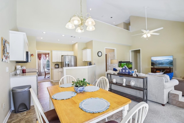 dining room with baseboards, high vaulted ceiling, a notable chandelier, and recessed lighting