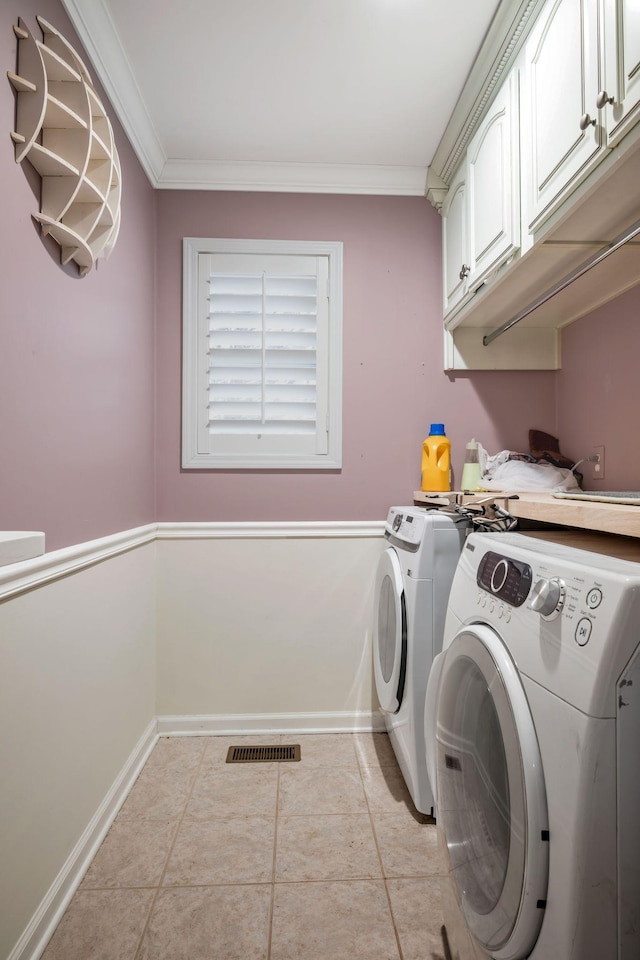 laundry room featuring ornamental molding, cabinet space, visible vents, and separate washer and dryer