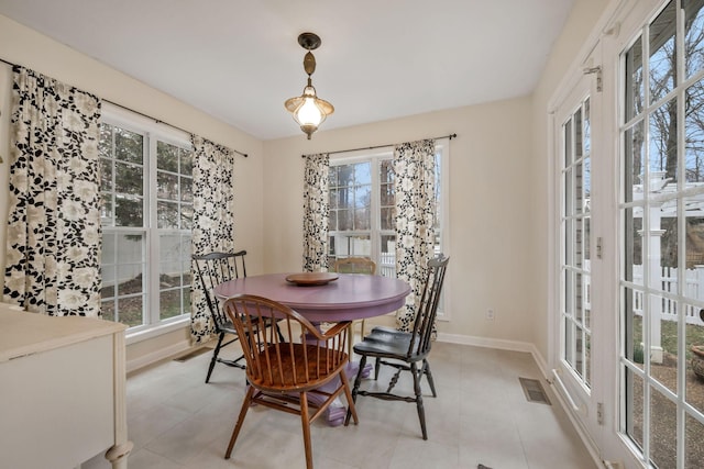 dining space featuring light tile patterned flooring, visible vents, and baseboards