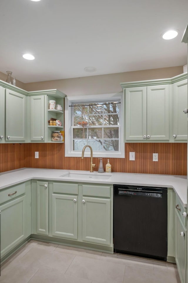 kitchen with a sink, green cabinets, dishwasher, and light countertops