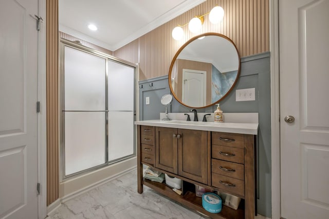 bathroom featuring ornamental molding, marble finish floor, a shower stall, and vanity