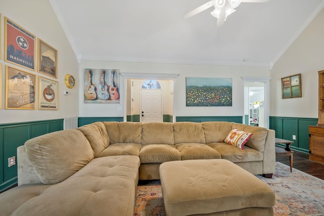 living room featuring a wainscoted wall, crown molding, vaulted ceiling, ceiling fan, and wood finished floors