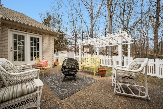 view of patio / terrace featuring a fenced backyard, a fire pit, and a pergola