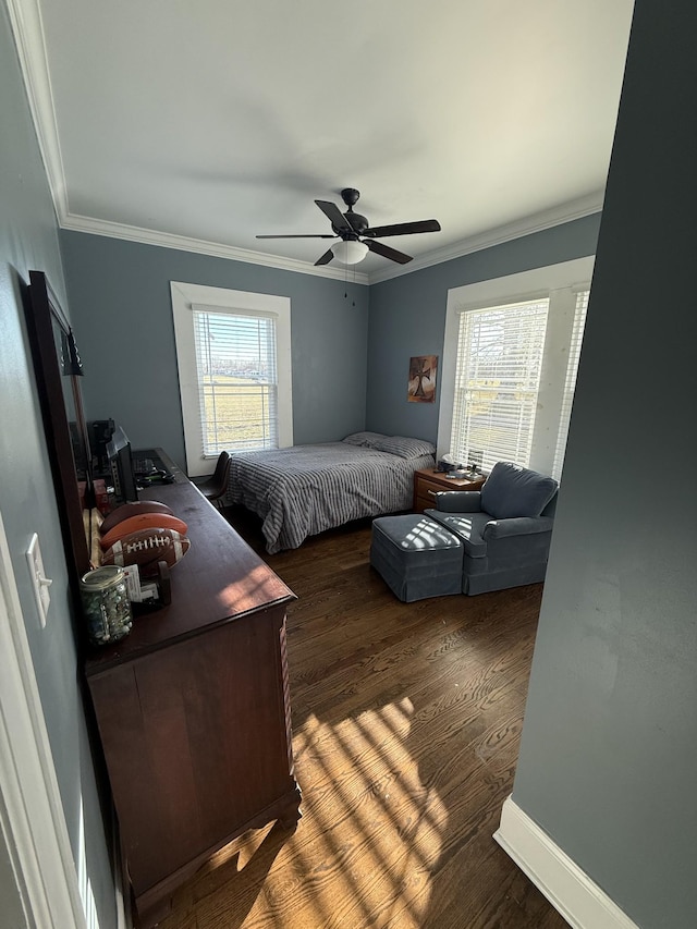 bedroom with ceiling fan, ornamental molding, wood finished floors, and baseboards