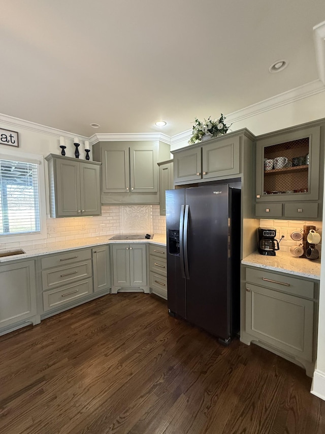 kitchen with gray cabinetry, dark wood-type flooring, crown molding, and stainless steel fridge with ice dispenser