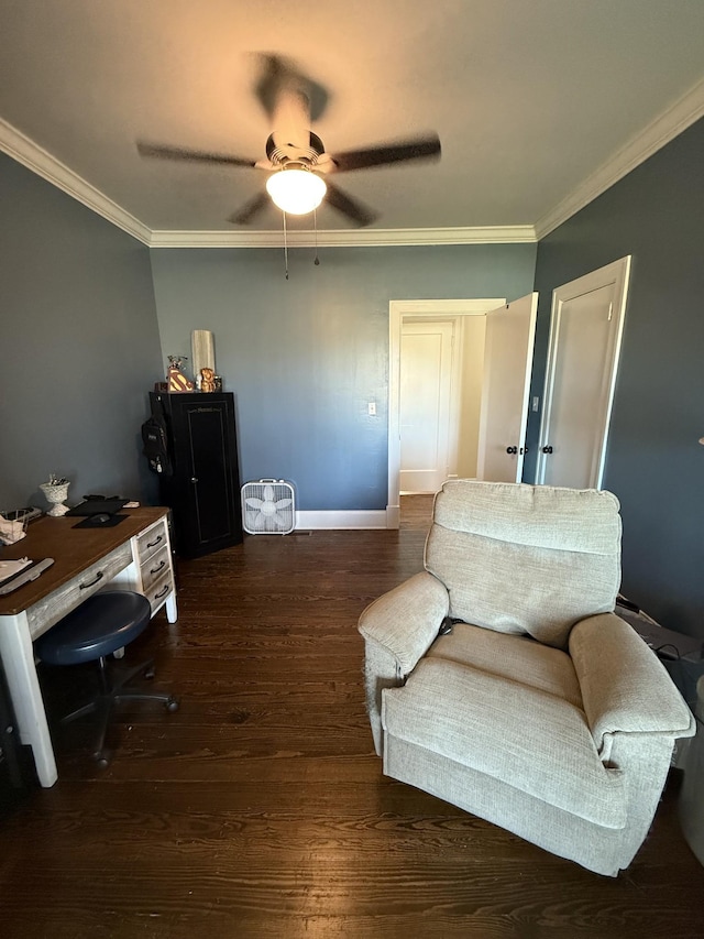 sitting room with a ceiling fan, baseboards, crown molding, and wood finished floors