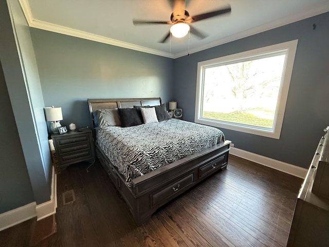 bedroom with baseboards, dark wood finished floors, a ceiling fan, and crown molding