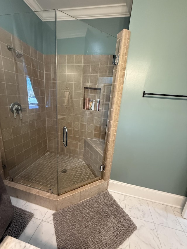 full bath featuring ornamental molding, a stall shower, marble finish floor, and baseboards