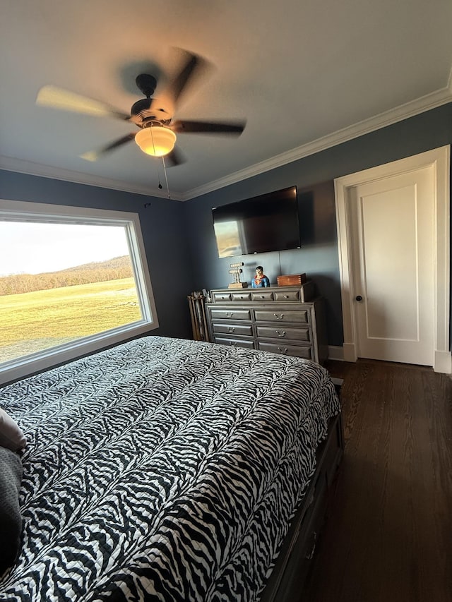 bedroom with ceiling fan, ornamental molding, and dark wood-style flooring