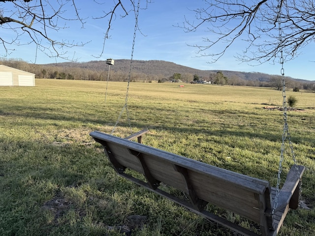 view of yard with a rural view and a mountain view