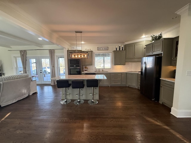 kitchen with gray cabinetry, black refrigerator with ice dispenser, a sink, and french doors