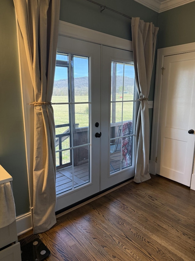 entryway featuring french doors, crown molding, and dark wood-style flooring