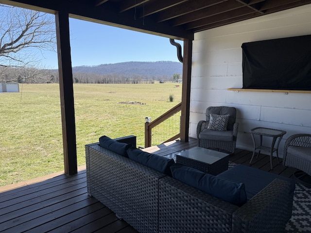 wooden deck featuring an outdoor hangout area and a lawn