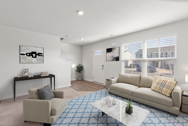 living area featuring carpet, visible vents, baseboards, and recessed lighting