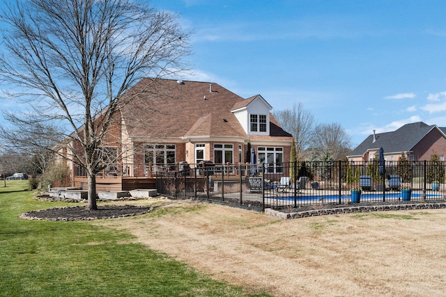 rear view of house featuring a fenced in pool, a yard, a patio, fence, and a wooden deck