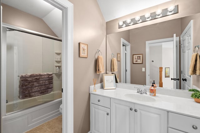 bathroom with combined bath / shower with glass door, vanity, toilet, and tile patterned floors