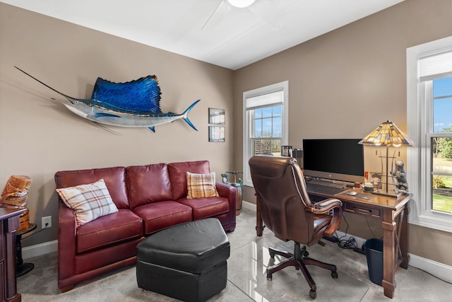 carpeted office space featuring baseboards