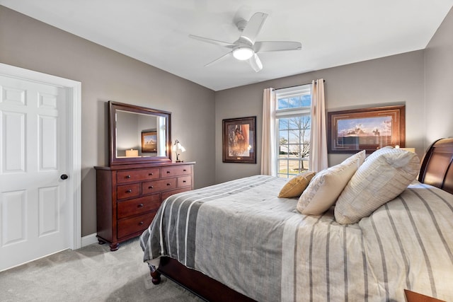 bedroom featuring light carpet, ceiling fan, and baseboards