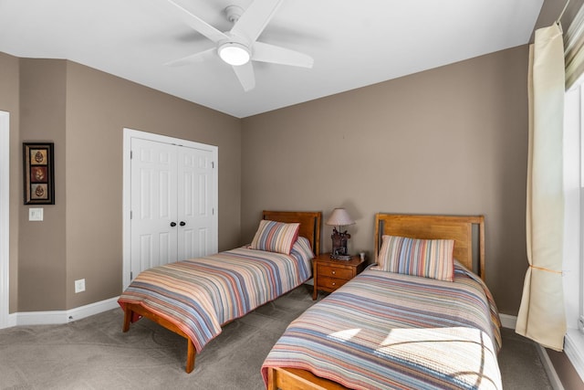 bedroom with a closet, carpet flooring, ceiling fan, and baseboards