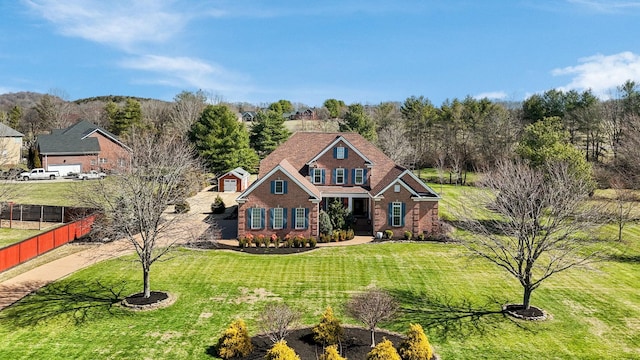 view of front of property featuring a front yard and fence