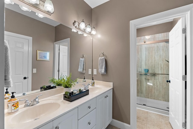 full bathroom with double vanity, a stall shower, and a sink