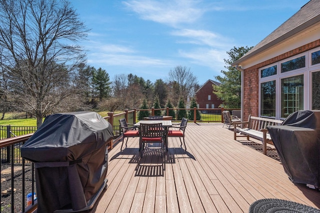 wooden terrace with outdoor dining space