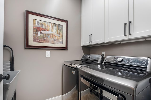 laundry area with cabinet space, independent washer and dryer, and baseboards