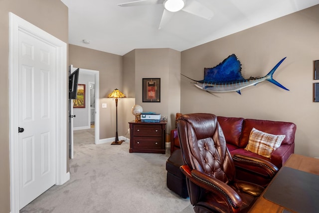 carpeted office with ceiling fan and baseboards