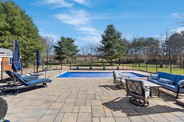 view of pool with a fenced in pool, a patio area, fence, and an outdoor hangout area