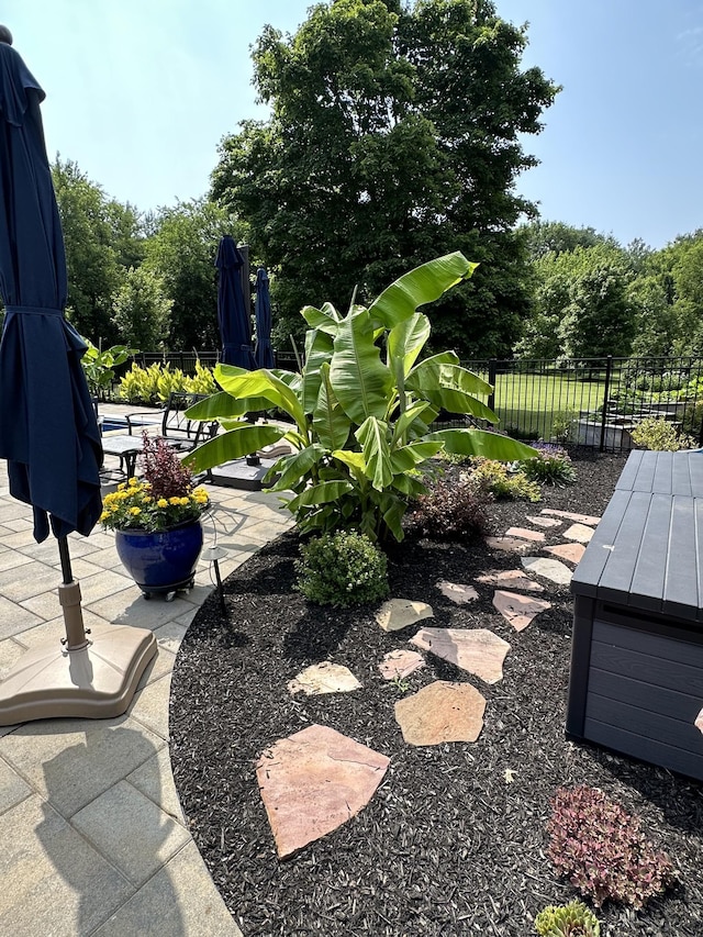 view of yard featuring fence and a patio