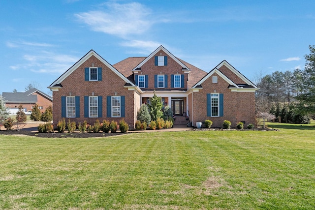 view of front of home featuring brick siding and a front lawn