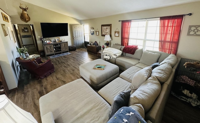 living area with vaulted ceiling and wood finished floors