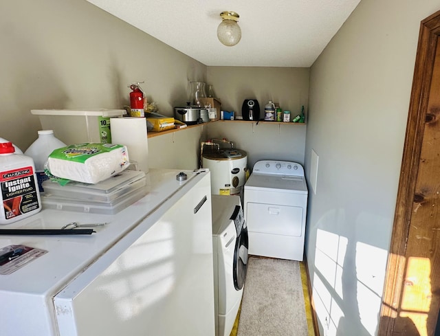 clothes washing area featuring laundry area, water heater, independent washer and dryer, and light carpet