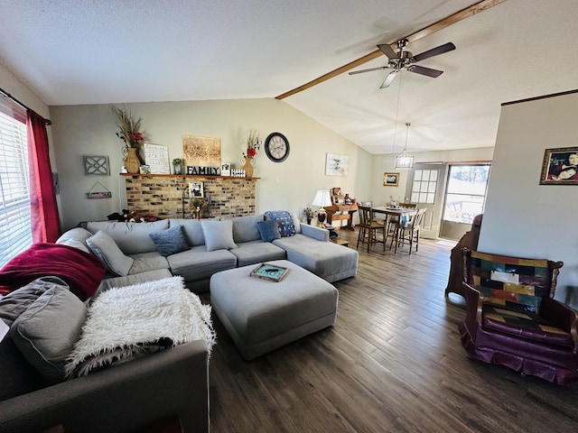 living room with vaulted ceiling, dark wood finished floors, a wealth of natural light, and a ceiling fan