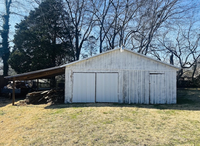 view of pole building with a carport and a lawn