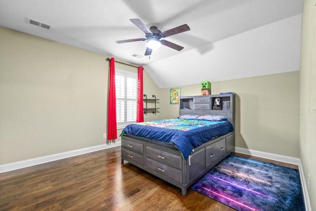 bedroom featuring lofted ceiling, wood finished floors, visible vents, and baseboards