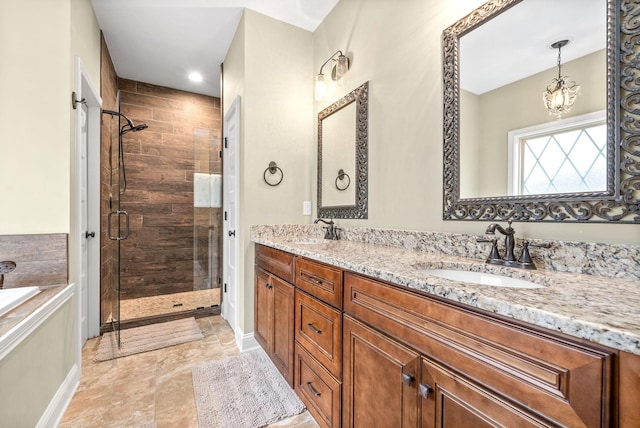 full bathroom with double vanity, a stall shower, a sink, and a bath