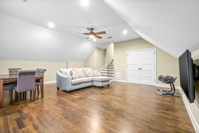 living area with wood finished floors, visible vents, and baseboards