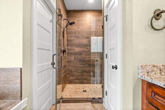 full bath featuring a stall shower and vanity