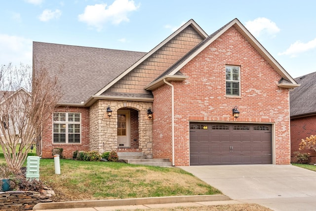 view of front facade with a front yard, concrete driveway, brick siding, and an attached garage