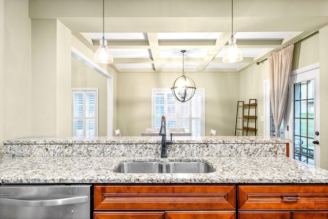 kitchen with dishwasher, a sink, and light stone countertops