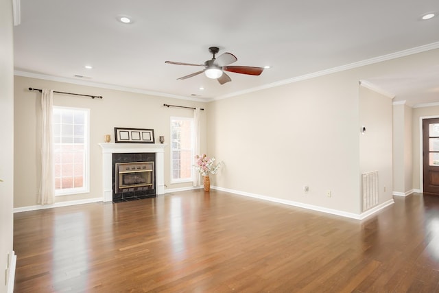 unfurnished living room with a fireplace with flush hearth, wood finished floors, visible vents, and crown molding