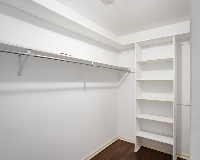 walk in closet featuring dark wood-type flooring