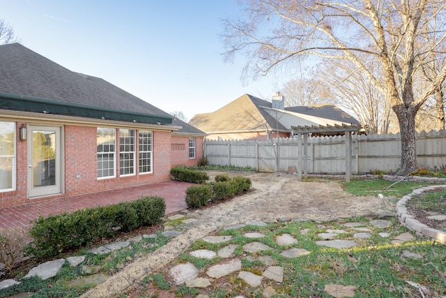 view of yard with fence and a patio