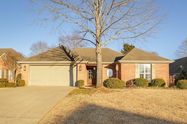 ranch-style house featuring a garage, concrete driveway, and brick siding