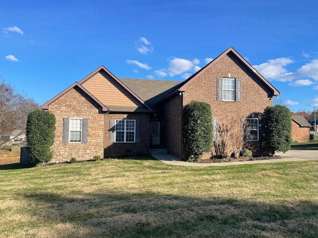 view of front facade with stone siding, brick siding, crawl space, and a front yard