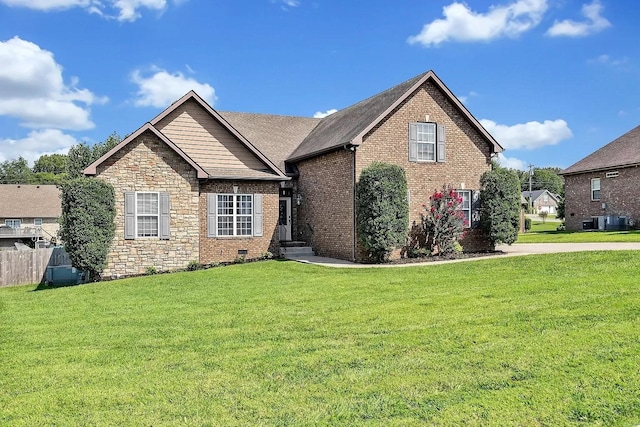 view of front of property with stone siding, crawl space, fence, a front lawn, and brick siding