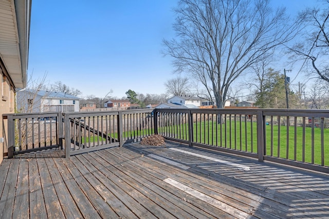 wooden deck featuring a residential view and a yard