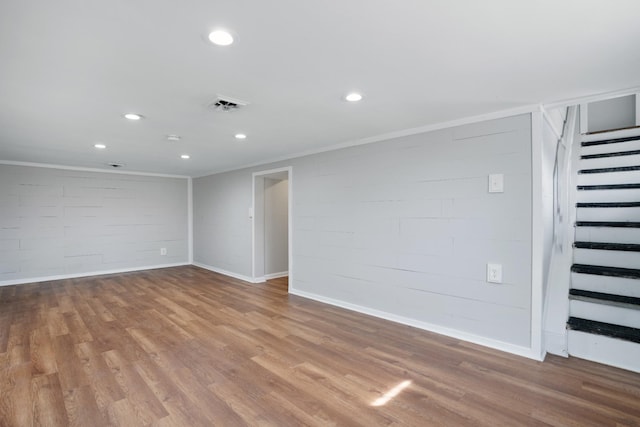 spare room with stairs, visible vents, wood finished floors, and recessed lighting